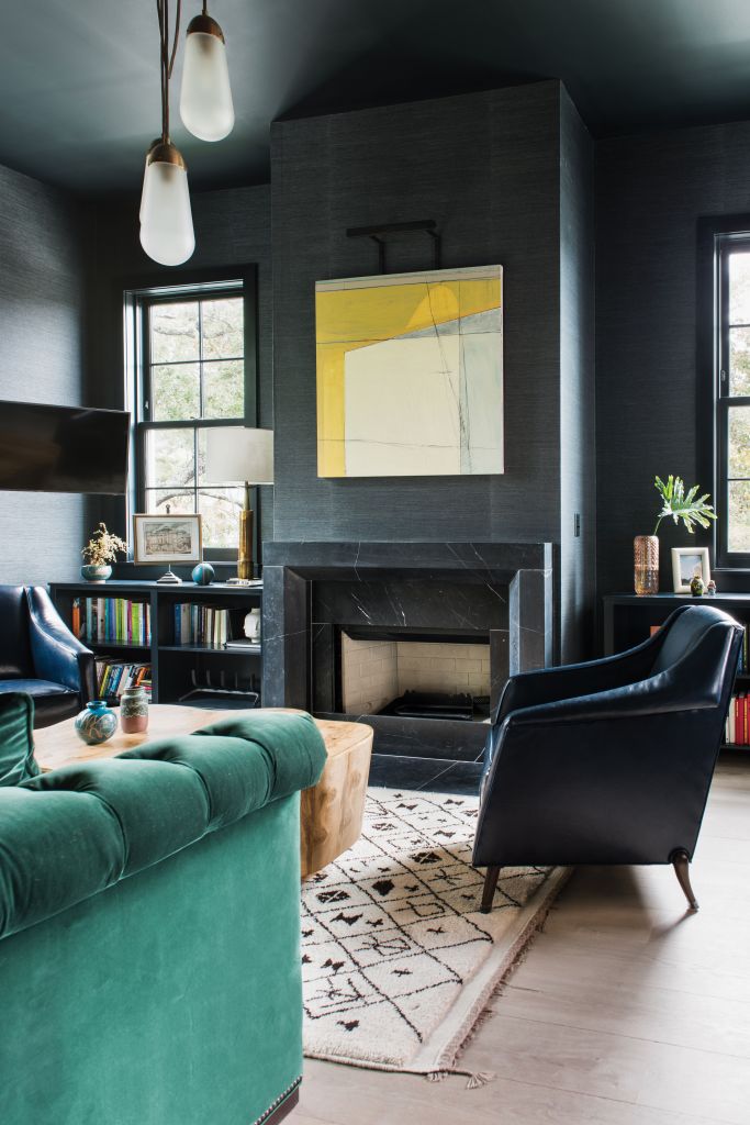 <strong>Moody Hues</strong> - The rich colors and textures in this High Battery library beckon for hours of rest, reading, and relaxation. For this cozy-meets-masculine space, interior designer Cortney Bishop covered the walls in Phillip Jeffries’s “Manila Hemp” paper in “charcoal” and had the Hickory Chair sofa upholstered in an emerald-green velvet by Ralph Lauren. Over the fireplace, an abstract work by Frank P. Phillips adds a sunny pop of color. <strong>Location:</strong> Downtown, South of Broad <strong>Issue:</strong> March 2018, “High Style on the Battery” <strong>Photographer:</strong> Katie Charlotte  <a href="https://charlestonmag.com/features/high_style_on_the_battery"><strong>&gt;&gt;CLICK HERE TO READ THE ARTICLE</strong></a>