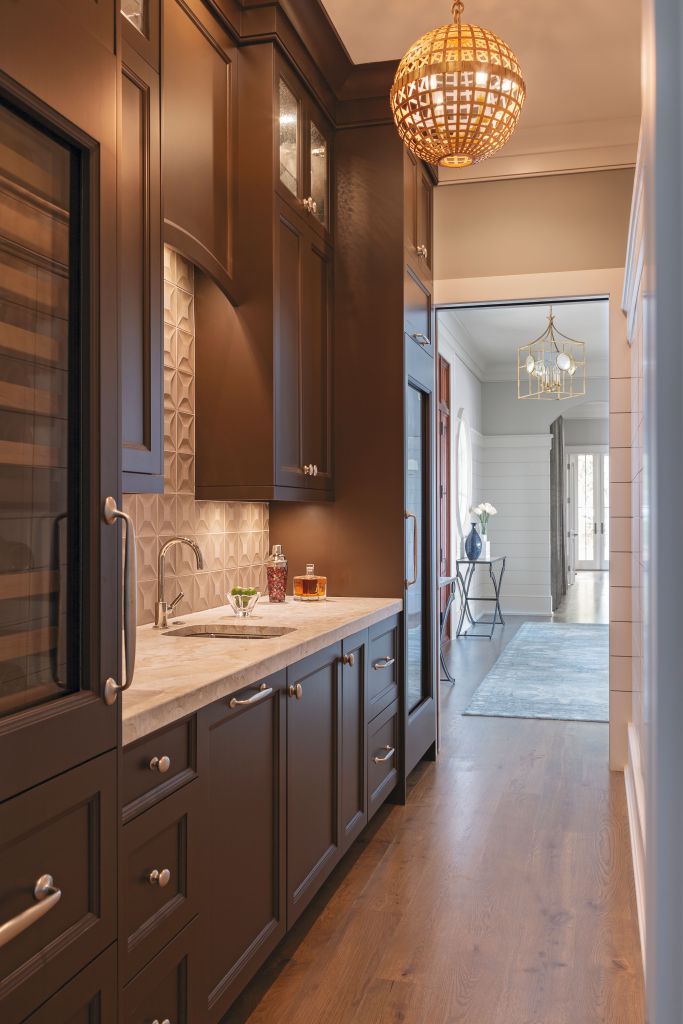 <strong>Handsome Hideaway</strong> - This hallway/pantry/bar is resplendent with floor-to-ceiling cabinets designed by Robert Paige Cabinetry. <strong>Location:</strong> James Island <strong>Issue:</strong> October 2019, “Outside In” <strong>Photographer:</strong> Julia Lynn  <a href="https://charlestonmag.com/features/outside_in"><strong>&gt;&gt;CLICK HERE TO READ THE ARTICLE</strong></a>