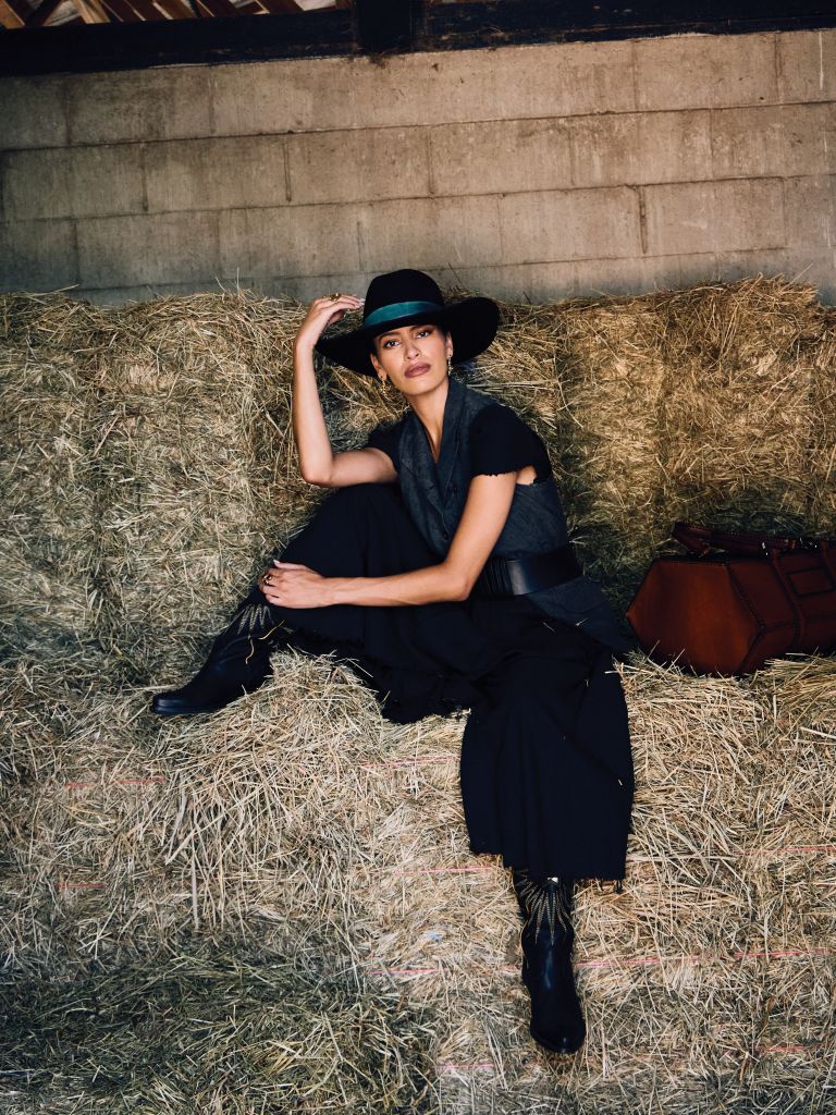 <b>Midnight Rider:</b> Atelier Suppan flared linen dress, $695, and Marc Le Bihan vest, $629, both at Worthwhile; Marsh &amp; Magnolia “Standard” hat, $175 at Marsh &amp; Magnolia; Johnny Farah leather belt, $308 at Havens, Golden Goose “Wish Star” leather boots, $960 at Golden Goose; Boysterous “The Horn Back Duffel,” $4,000 at Boysterous; Capucine De Wulf “Blandine” earrings, $95 at Rhodes Boutique; Gold Creations rice bead station necklace, $395 at Gold Creations; handmade, 22K-gold-plate rings with semiprecious stones, $90 each at 7 Hills Living.