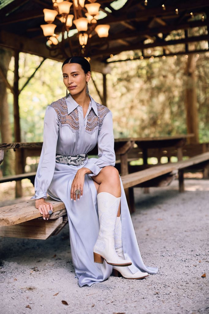 <b>Urbane Cowgirl:</b> St. John satin and lace Western-style gown, $2,495 at St. John; W. Kleinberg python belt, $595 at RTW; leather boots, $400 at 7 Hills Living; Jean-Francois Mimilla earrings, $295 at Worthwhile; Rosa Maria “Flavie Moon” moonstone and diamond ring, $2,468 at Havens; Virgins Saints &amp; Angels “Cloister San Benito” ring, $230 at Copper Penny.