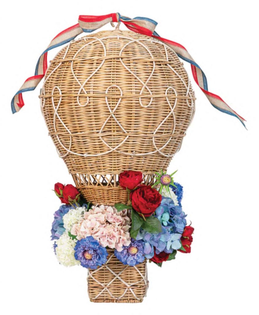 <i>The whimsi</i><i>cal “Provence” rattan hot air balloon basket that she dreamed up, inspired by their wedding china. The bestseller comes in three sizes.</i>