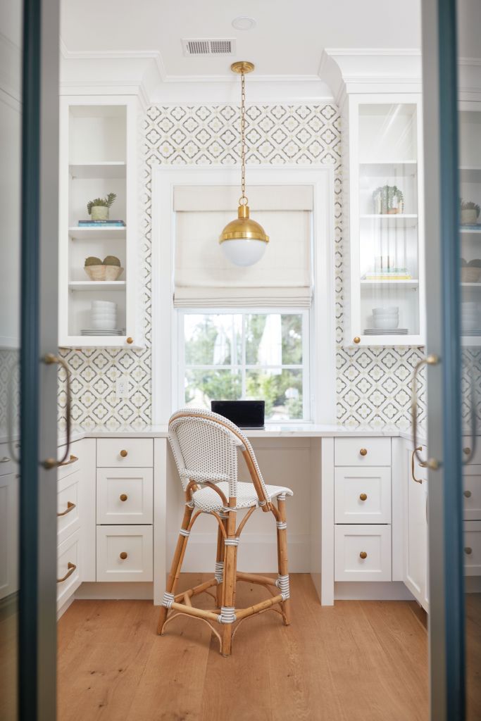 <strong>Double Duty</strong> - Hidden behind two doors integrated into the kitchen cabinetry, this cheerful space, featuring Tabarka handmade terra-cotta tile, also serves as a home office. <strong>Location:</strong> West Ashley <strong>Issue:</strong> June 2023, “Room to Grow” <strong>Photographer:</strong> Blake Shorter  <a href="https://charlestonmag.com/features/after_snapping_up_a_choice_lot_on_the_ashley_river_a_couple_built_a_family_home_that"><strong>&gt;&gt;CLICK HERE TO READ THE ARTICLE</strong></a>