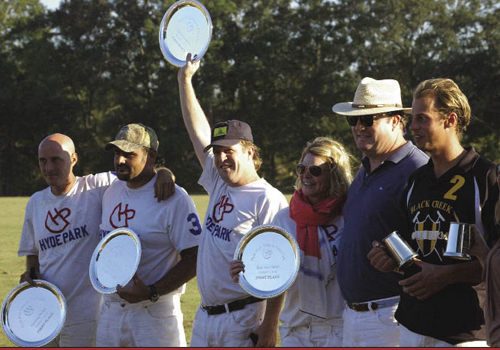 Presenting the silver, like stomping the divots, is a cherished ceremony. Plates go to the members of the winning team, cups to the runners-up. After the presentation, players talk to the fans, sit their children on the ponies, and explain the game to newcomers. Amy Vann Flowers (right, center) presides over this ceremony at Hyde Park Farm &amp; Polo Club, a full-service polo school and facility that she built on family property near Ravenel.